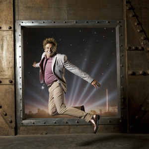Rod Stewart's album cover for 'Atlantic Crossing'. Futuristic theme with Rod in mid-jump. Dark space elements, streaks of light, and a cityscape in soft pinks and blues with various lighting effects.