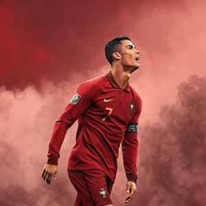 Digital illustration of Cristiano Ronaldo in a dynamic pose. Background is foggy and smoky. He's the central figure. Rich red color scheme.