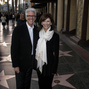 Ted Danson and Mary Steenburgen at the Hollywood Walk of Fame event. Ted in black suit, Mary in black top and large white scarf, both smiling for the camera.