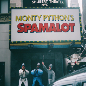 Lively Billboard for 'Monty Python's Spamalot' at Shubert Theater NYC. Digital art style. Vibrant colors - blue knights, red knights, and yellow backdrop. Monty Python characters in action scenes. Show dates highlighted in bold red. Ticket info in blue.