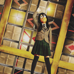 Tsuyu Asui, hero of My Hero Academia, standing on her hands. Vibrant background with geometric shapes and bold colors