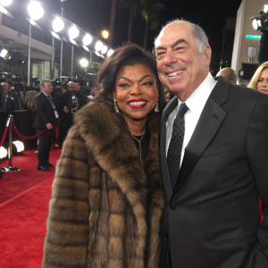 Taraji P. Henson and Gary Newman at a glitzy Hollywood awards show. Both are beaming, Taraji in a luxurious fur coat, Gary in a sharp suit.