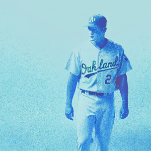 Chris Coghlan, baseball player, dressed in white jersey with Oakland Athletics logo. Studio portrait, plain background