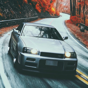 Custom Nissan Skyline GTR R34 Z-Tune, painted in matte grey, racing down a winding mountain road surrounded by vibrant autumn foliage.