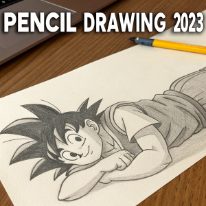 Pencil sketch of Goku from Dragon Ball Z. Lying on a desk with an unused pencil nearby. Text above reads 'Pencil Drawing 2023'