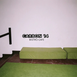 Logo design for Carbon 14 Bistro Cafe. Simple, clean aesthetic with geometric elements. Muted green and black palette. Light grey backdrop.
