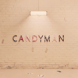 Poster for Candyman. Graffiti-covered brick wall backdrop, neon lights shining through
