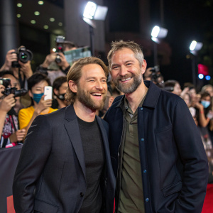 Aaron Moorhead and Justin Benson, directors of 'Moon Knight,' posing at the premiere event. Surrounded by flashing cameras and fans.