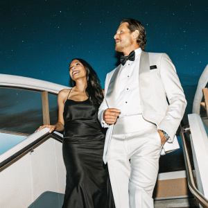 Rosario Dawson and Jason Lewis at a Hollywood event. Both wearing formal attire. Dark, starry night backdrop.