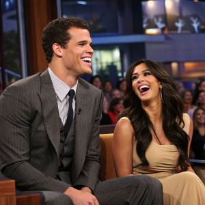 Kris Humphries and Kim Kardashian on Jay Leno's Tonight Show. All three are laughing. Studio audience in the background.