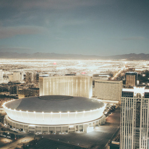 A stunning nighttime aerial view of T-Mobile Arena in Las Vegas, surrounded by the vibrant city lights.