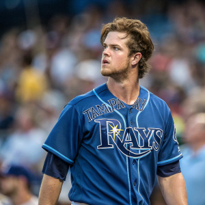 Wil Myers, baseball player, intense look, blue jersey with 'Tampa Bay Rays' logo. Crowd blurred in background