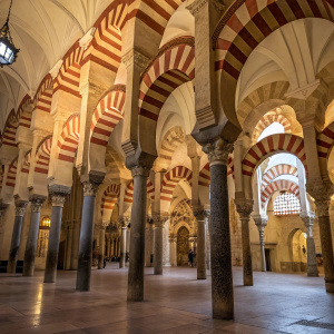 Inside the Mezquita of Córdoba, columns reach towards the sky, creating a mesmerizing pattern.