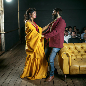 Chitrangada Singh and Shaad Ali at a book launch event. Chitrangada points towards Shaad, who is bearded. Indoor setting with audience present.