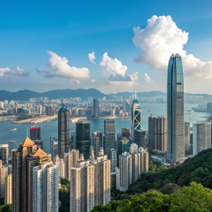 Panoramic view of Hong Kong's bustling downtown area. Skyscrapers and modern architecture towering over traditional structures. Clear blue sky dotted with fluffy clouds.