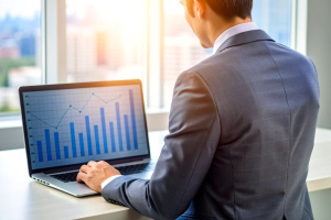 Cropped photo of businessman analyzing business diagram, marketing statistics and finance market graphs on laptop monitor in the office