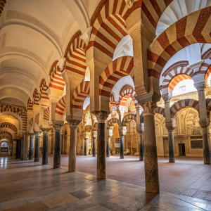 A panoramic view inside the Mosque-Cathedral of Cordoba, Spain. Looking through intricate archways.