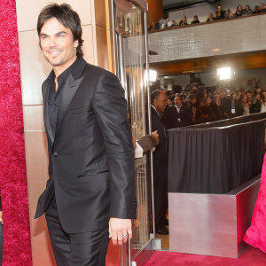 Ian Somerhalder, dressed in a sleek black suit, at the bustling entrance of the Golden Globe Awards.
