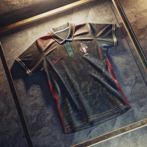 Cristiano Ronaldo's signed jersey. On display in a glass case at the football museum. Dark background