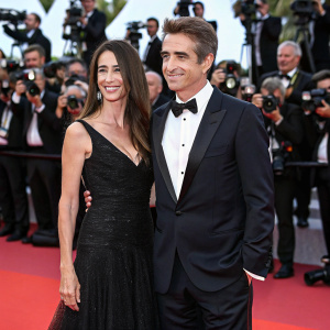 Dermot Mulroney and Tharita Catulle at Cannes Film Festival. Glamorous red carpet, paparazzi flashing lights
