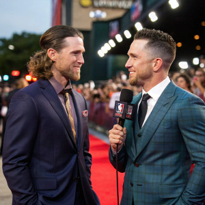 Josh Reddick and Alex Bregman from the Houston Astros team during an interview at the MLB Awards. They are wearing suits and standing in front of a crowd.