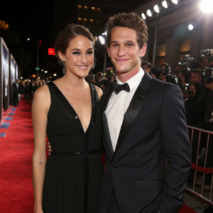 Shailene Woodley and Daren Kagasoff at a movie premiere. Both wearing formal attire. Bright lights and red carpet visible in background.