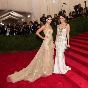 Ursula Corbero and Maria Leon arriving at the Met Gala. Red carpet, flashing cameras, and a star-studded crowd.
