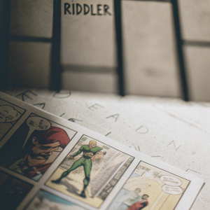Comic book page featuring the Riddler. Detailed line art and dynamic action scenes. Dark backgrounds with splashes of vivid color. Grid layout with speech bubbles