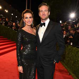 Elizabeth Chambers and Armie Hammer attend the Vanity Fair Oscar Party. Elizabeth in a stunning black sequined dress, Armie in a classic black tuxedo. Both on the red carpet.