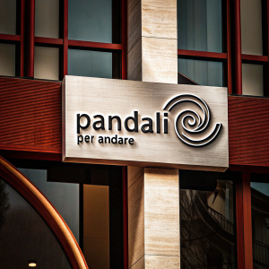 A sleek logo for the brand Pandali Per Andare, meaning 'Pandali With Attitude' in Italian. The design features a swirling graphic element beside modern sans-serif text. Monochromatic palette with the logo text in a dark shade on a plain white backdrop.