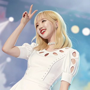 Eunha from GFriend, with blonde hair and a cheerful expression, performing a playful hand sign. Wearing a white dress with cut-out details. The background is blurred with a mix of blue and other colors.