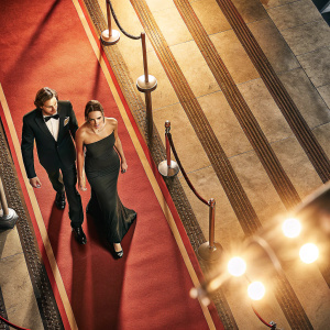Jamie Campbell Bower and Matilda Lowther attending a charity gala. They both wear formal attire. Elegant red carpet, spotlights