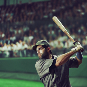 Yoenis Cespedes, baseball player, in intense batting stance. Gray jersey and cap. Crowd blurred in the background, focus on dramatic moment