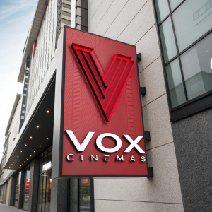 A modern logo for Vox Cinemas. Design features a stylized 'V' in vibrant red with sleek black accents. Contemporary style