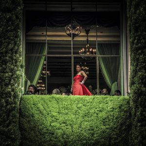 Morena Baccarin, wearing a vibrant red dress, at the Met Gala event.