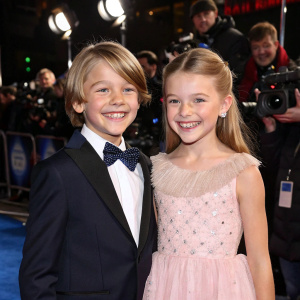 Joel Dawson and Pixie Davies at the Hollywood premiere of Mary Poppins Returns. Posing with a big smile in front of flashing cameras and paparazzi.