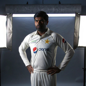 Haris Sohail, cricketer, posing in a white jersey with prominent Pepsi logo and yellow star. Dark studio background, professional photo