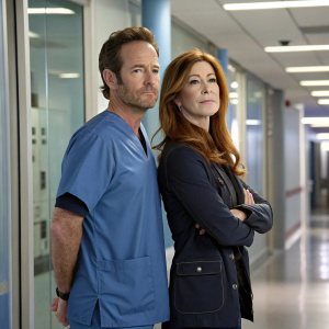 Luke Perry and Dana Delany, actors from 'Body of Proof', standing in a modern hospital corridor. Luke in a blue scrubs, Dana with long auburn hair, both looking serious. High-tech medical equipment in the background.