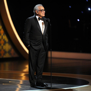 Director Martin Scorsese at the 63rd Primetime Emmy Awards. Wearing a black tuxedo, standing solo on a stage. Spotlighted