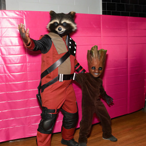 Rocket Raccoon and Baby Groot, colorful characters from Guardians of the Galaxy. Animated, playful scene