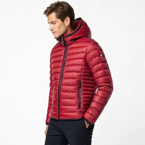Moncler men's Rigel jacket, a red, full-length winter coat with a zipper closure, designed for extreme cold. It features synthetic insulation.