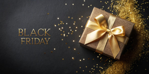 Gift box and golden ribbon on black background with glitter. Black friday sale concept. Banner