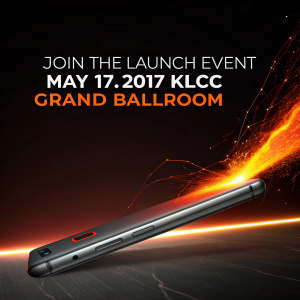 A sleek and modern gadget, bathed in a fiery glow against a dark backdrop. The call: Join the launch event on May 17, 2017, at the KLCC Grand Ballroom. Witness the convergence of technology and the digital world as vibrant hues of orange and darkness create an electrifying scene.