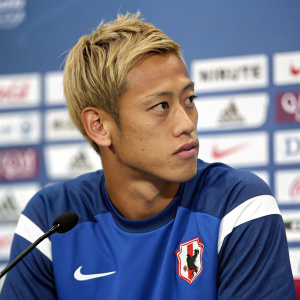 Keisuke Honda, soccer player, in blue and white Nike jersey, focused look, during indoor press conference