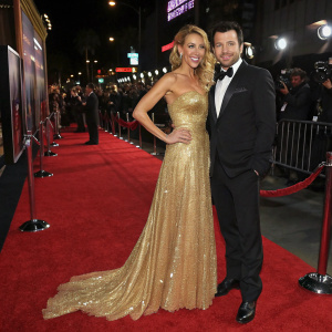 Elsa Pataki and Michael Youn attending a glitzy Hollywood movie premiere. Elsa Pataki in a stunning strapless gold gown