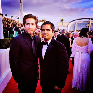 Jake Gyllenhaal and Michael Pena, dressed in black suits, at the Golden Globe Awards. Crowds in the background