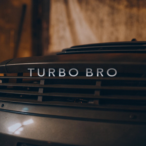 The Turbo Bro logo, prominently displayed against a stark white backdrop. The design is sleek and modern, with sharp edges and bold colors.
