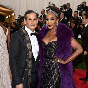 Phillip Bloch and Vivica A Fox at the Met Gala, wearing extravagant evening wear. Crowded red carpet scene.