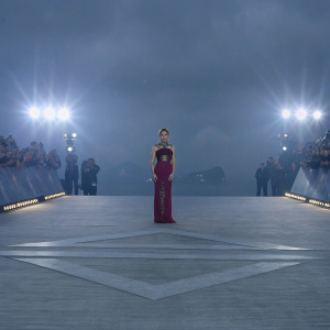 Scarlett Johansson, in a dramatic red dress with gold embellishments, at a movie premiere. Crowded venue, flashing cameras.