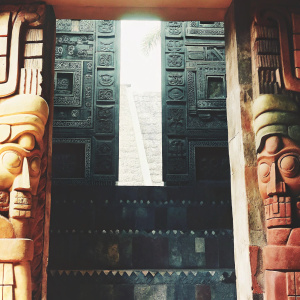 Close-up view of intricate carvings at the ancient Mayan temple in Guatemala. Detailed hieroglyphs and sculptures depicting mythological figures. Stone walls covered with ancient symbols.